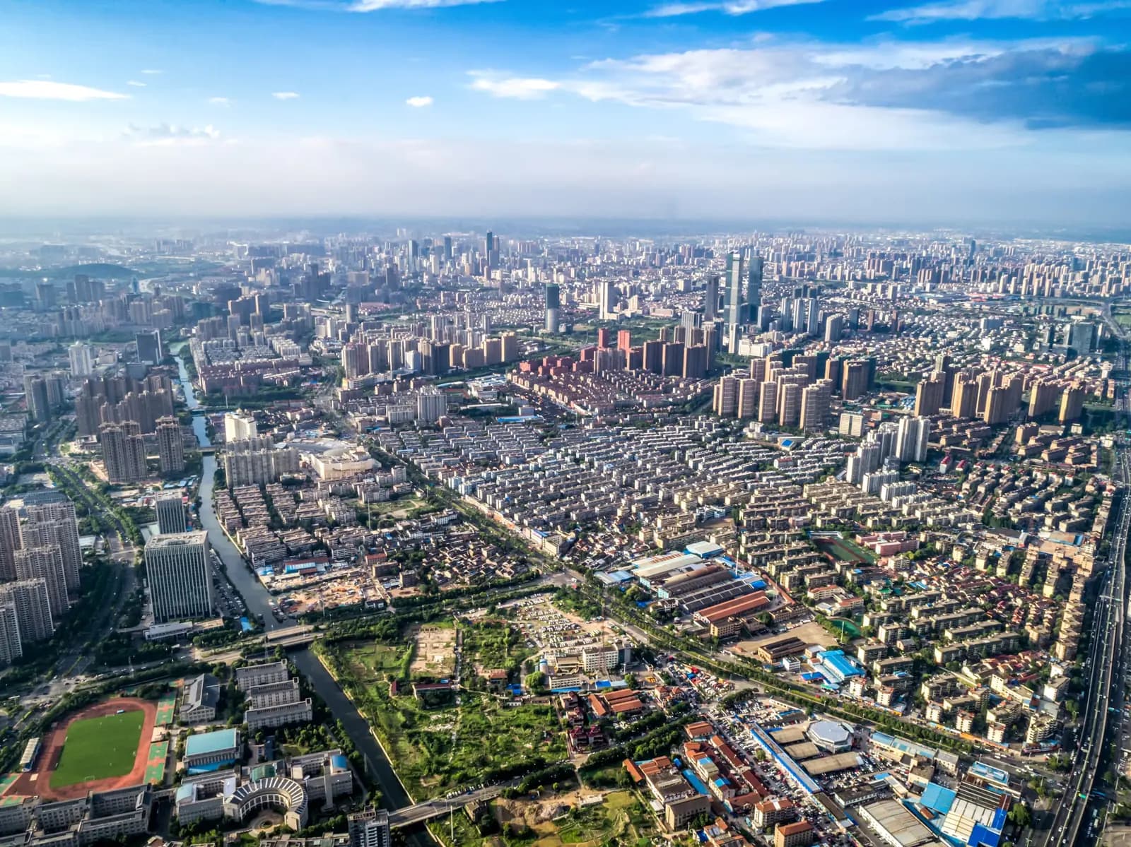Aerial view of a sprawling modern city with commercial districts