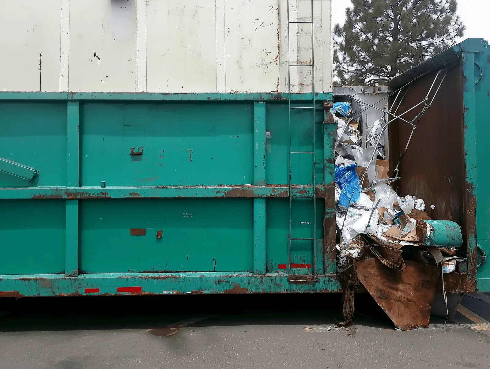Large green roll-off container staged for pickup